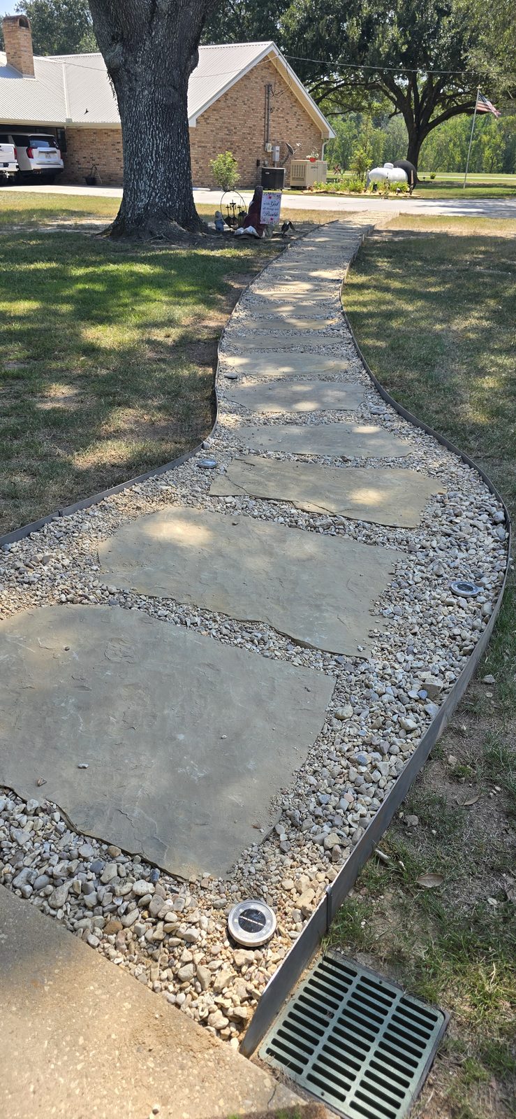A finished flagstone-and-gravel walkway installed by Steven Barnes in Acadiana